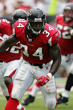 Ovie Mughelli running with the football in a Falcons jersey